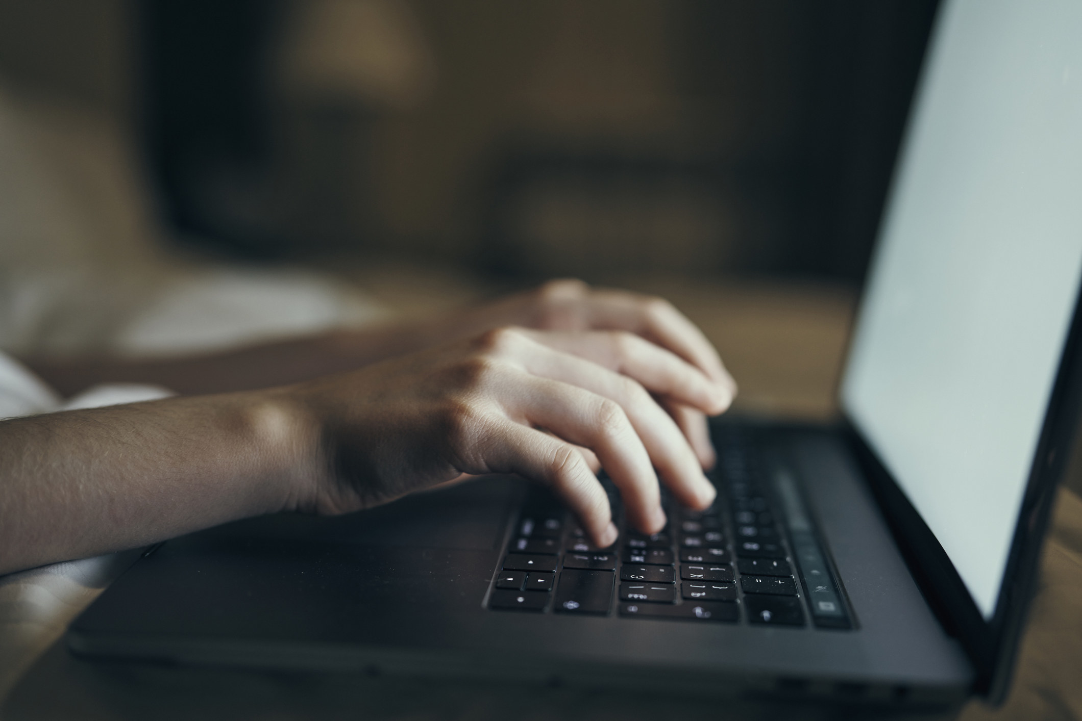 A person typing on a laptop