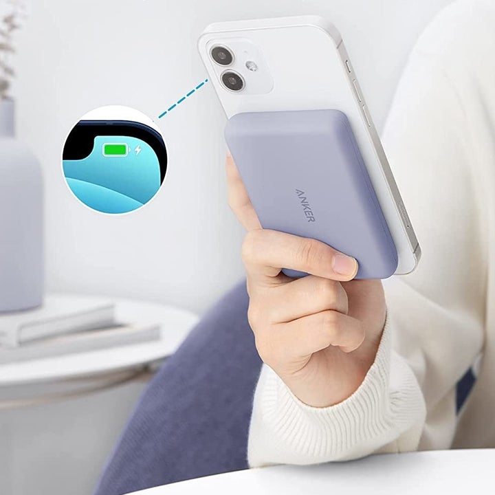 a model using the charger while it's attached to their iPhone 12