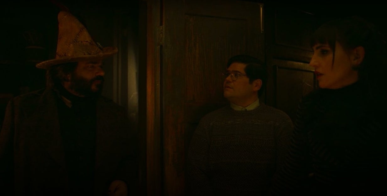 Laszlo, wearing his witch hat, talking to Nadja and Guillermo in &quot;What We Do in the Shadows&quot;