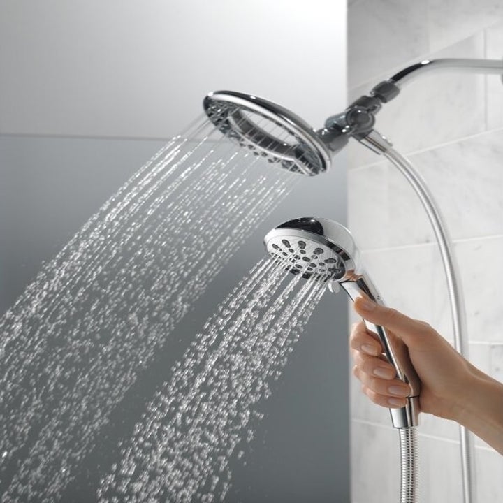 the showerhead and a hand holding the removable shower head