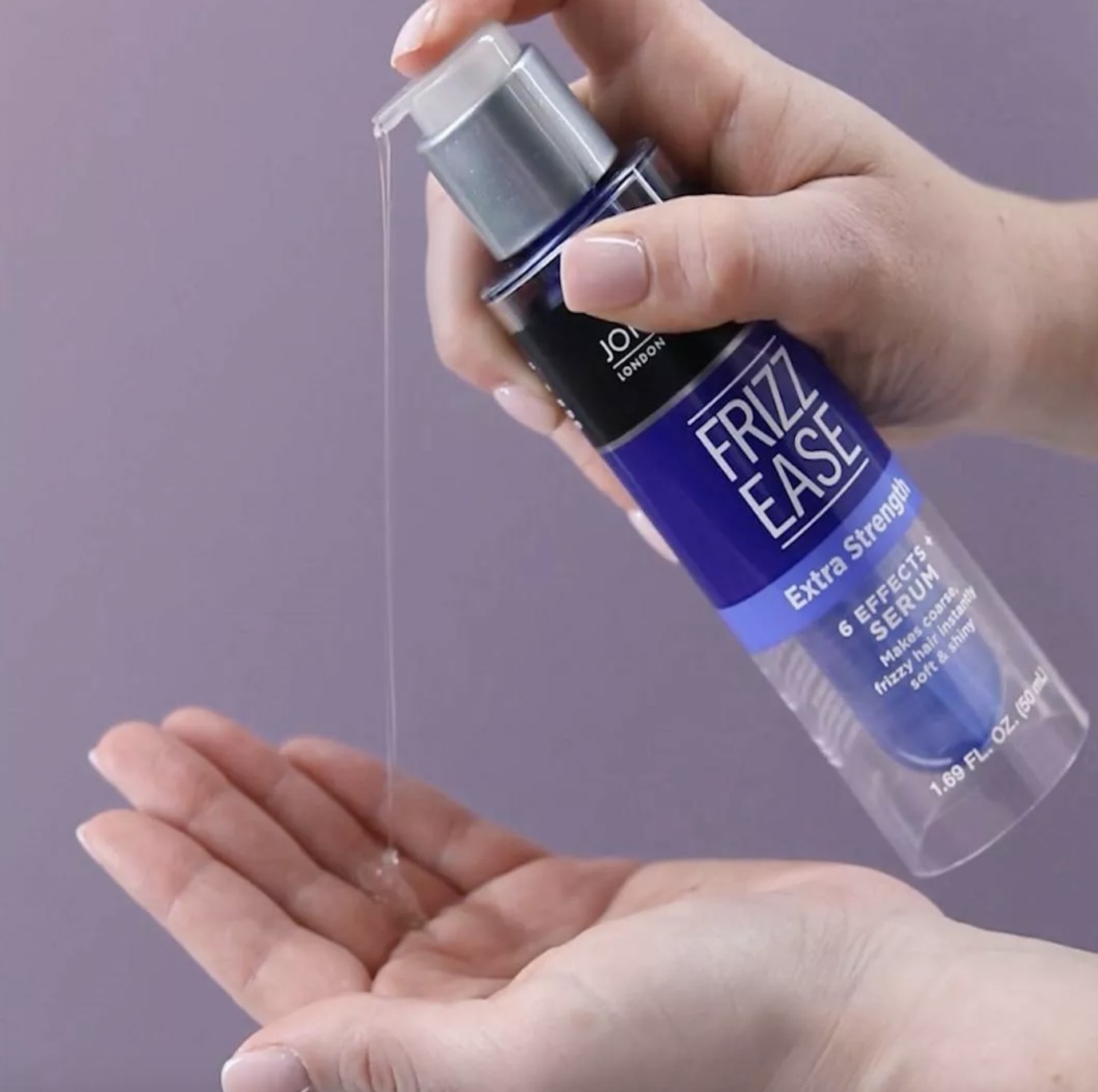 A person pouring out hair serum