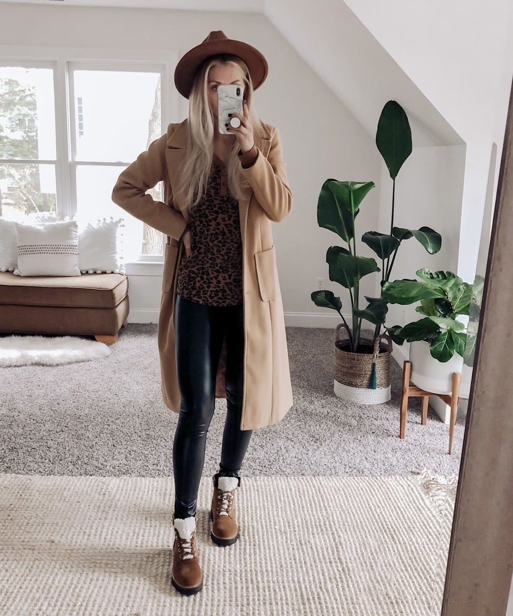 reviewer wearing the long coat in tan with a leopard shirt and brown boots