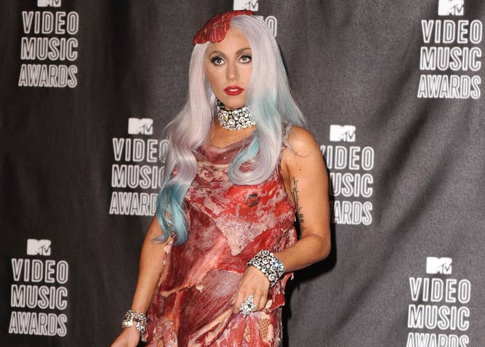 Gaga wears a dress made of red meat including a hat and purse