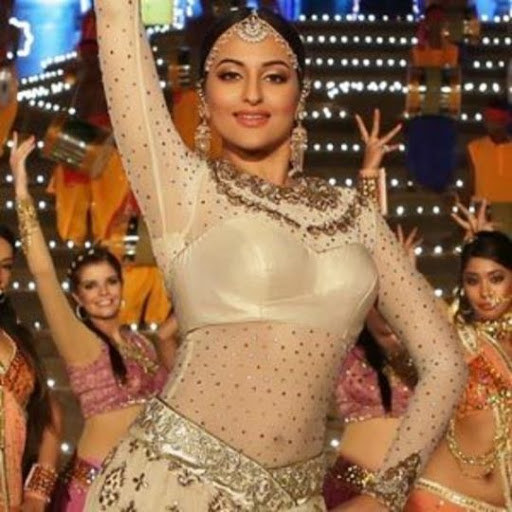 Bollywood actress Sonakshi SInha dressed and dancing in a beige shimmery lehenga in a song from the movie Tevar.