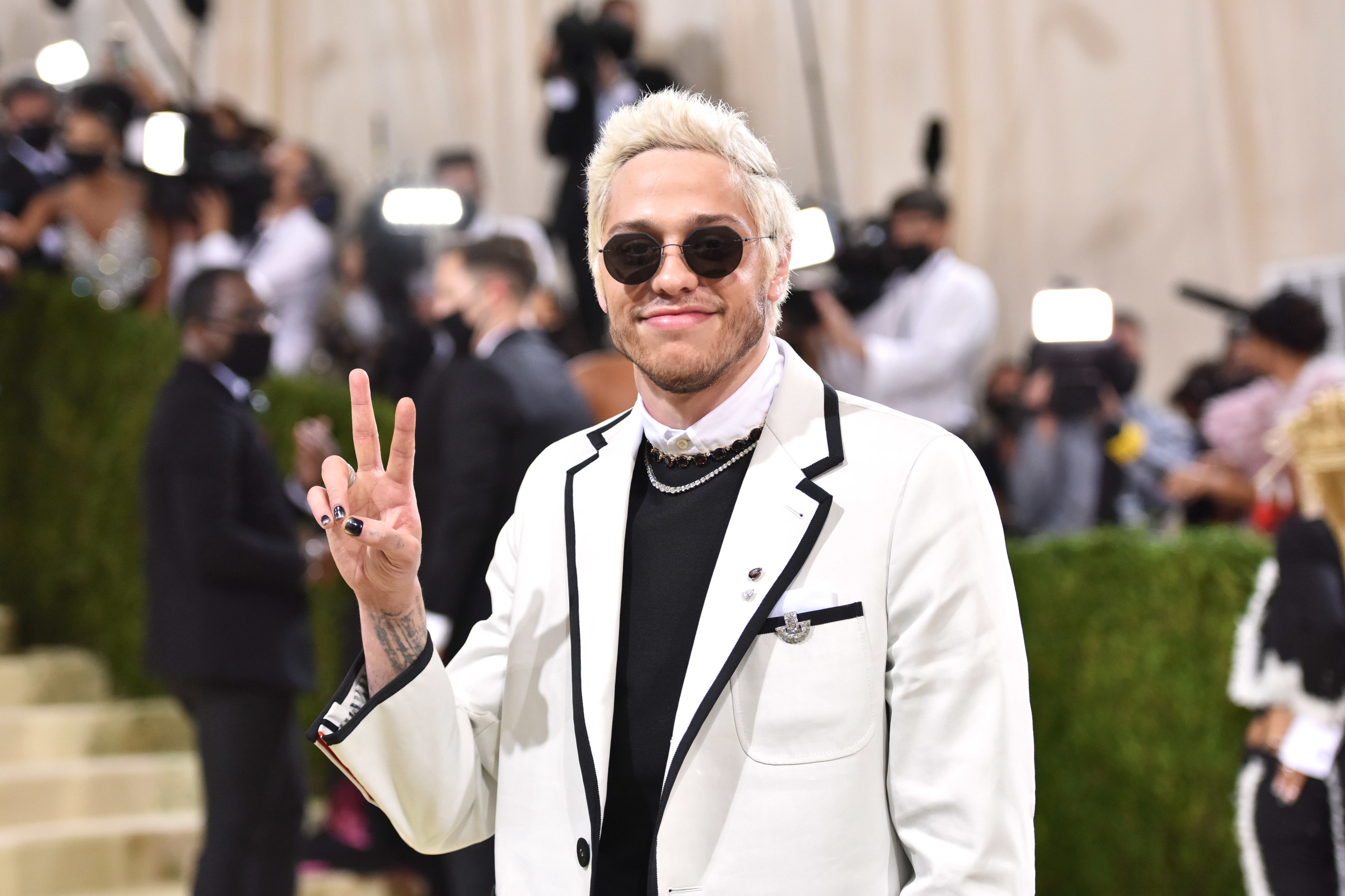 Pete giving the peace sign on the red carpet of the 2021 Met Gala