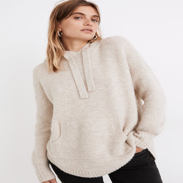 model wearing the cream hoodie sweater
