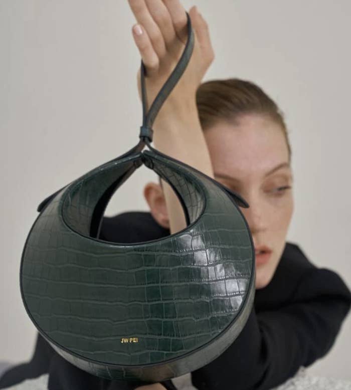 round green croc embossed handbag