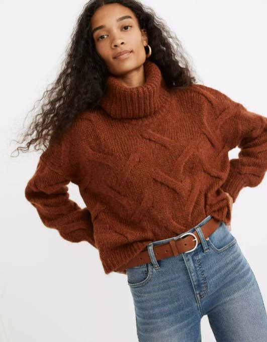 model wearing the sweater in brown with jeans and a matching brown belt