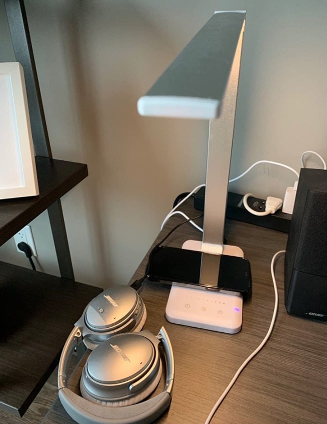 A silver light being used and phone being charged in a reviewer&#x27;s home