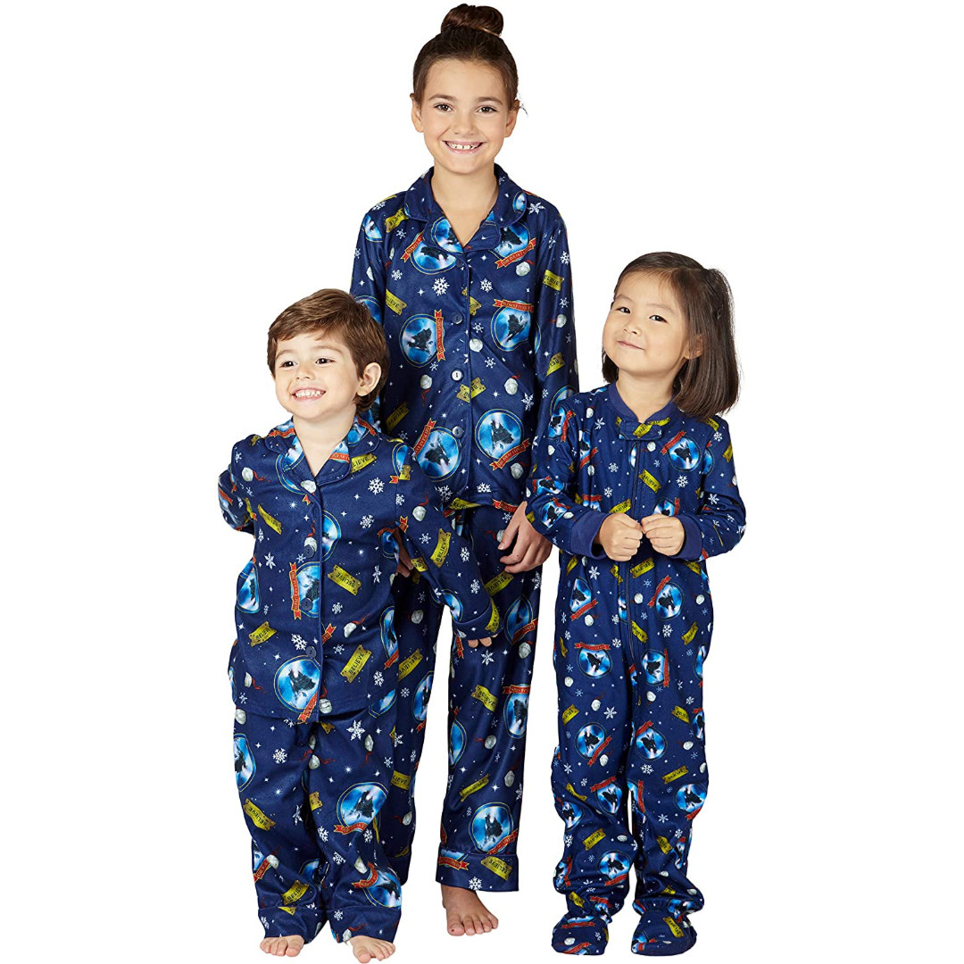three kids in blue button up shirts and pants with the polar express icon on them