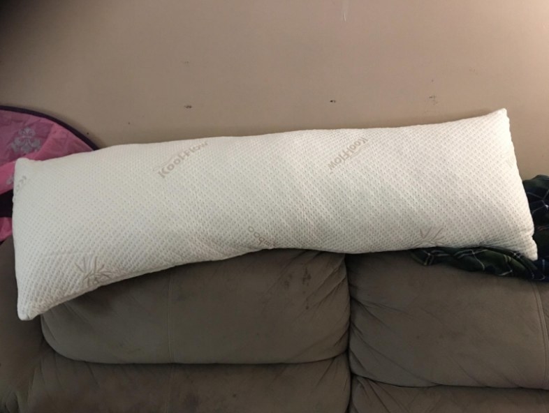 A white body pillow in a reviewer&#x27;s home