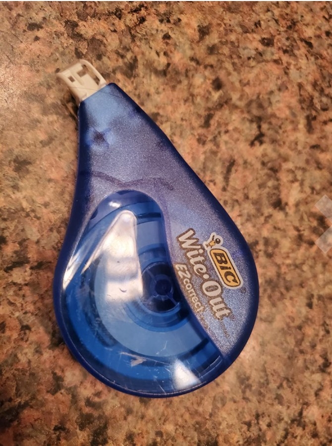 A  reviewer&#x27;s blue correction tape on a table
