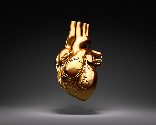 a human heart statue in gold