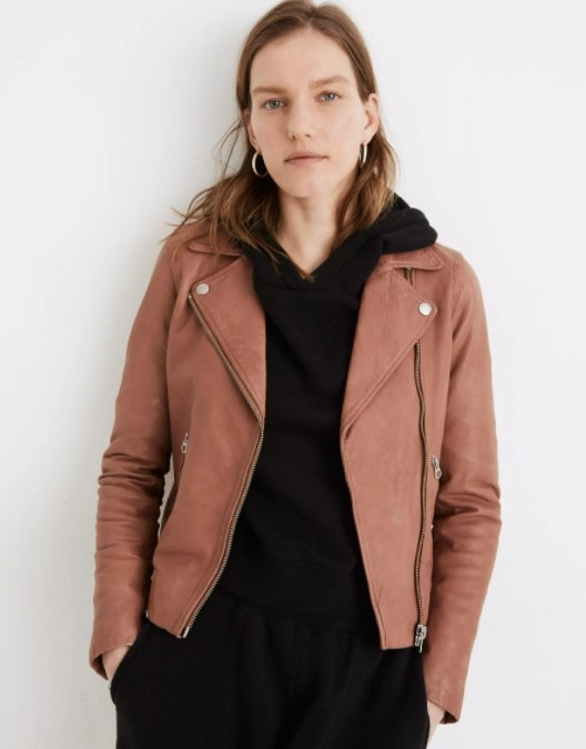 model wearing the jacket in light brown over a black sweatshirt and black sweats
