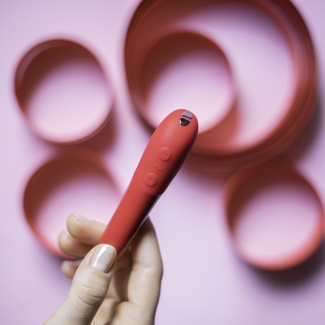 Model holding red Tango X bullet vibrator