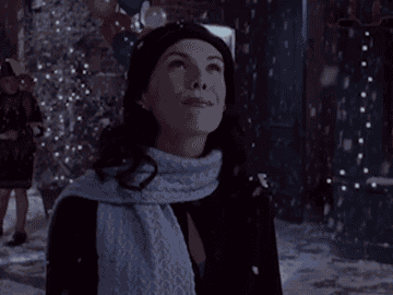 Lorelai looking up at the snow in Gilmore Girls