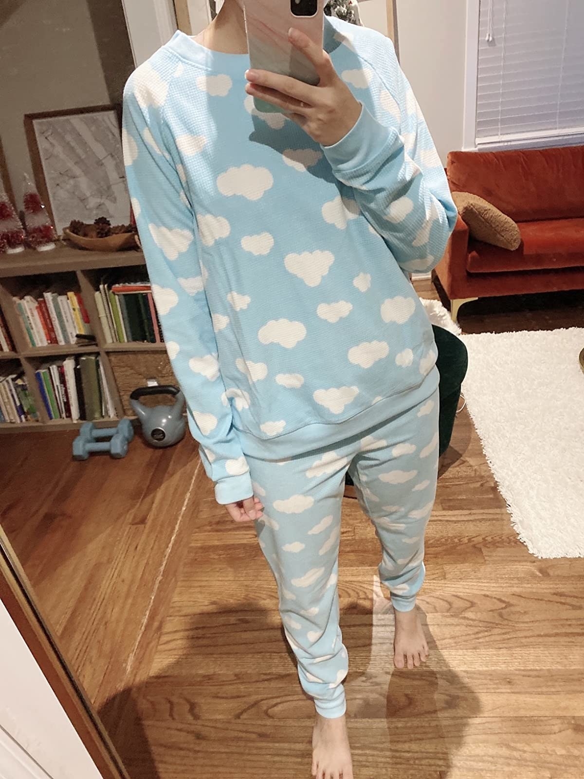Reviewer is wearing a sky blue pajamas set with white clouds throughout