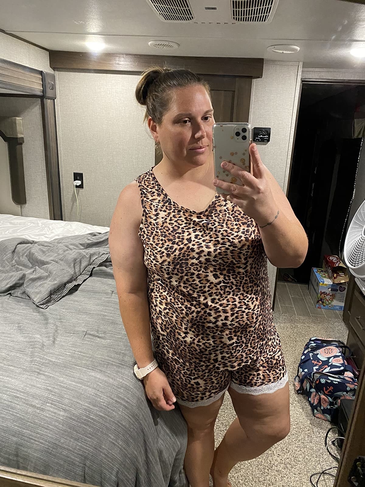 Reviewer is wearing a leopard print tank top and short pajama set