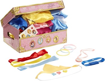 A half open pink trunk showing the costumed folded up inside surrounded by accessories