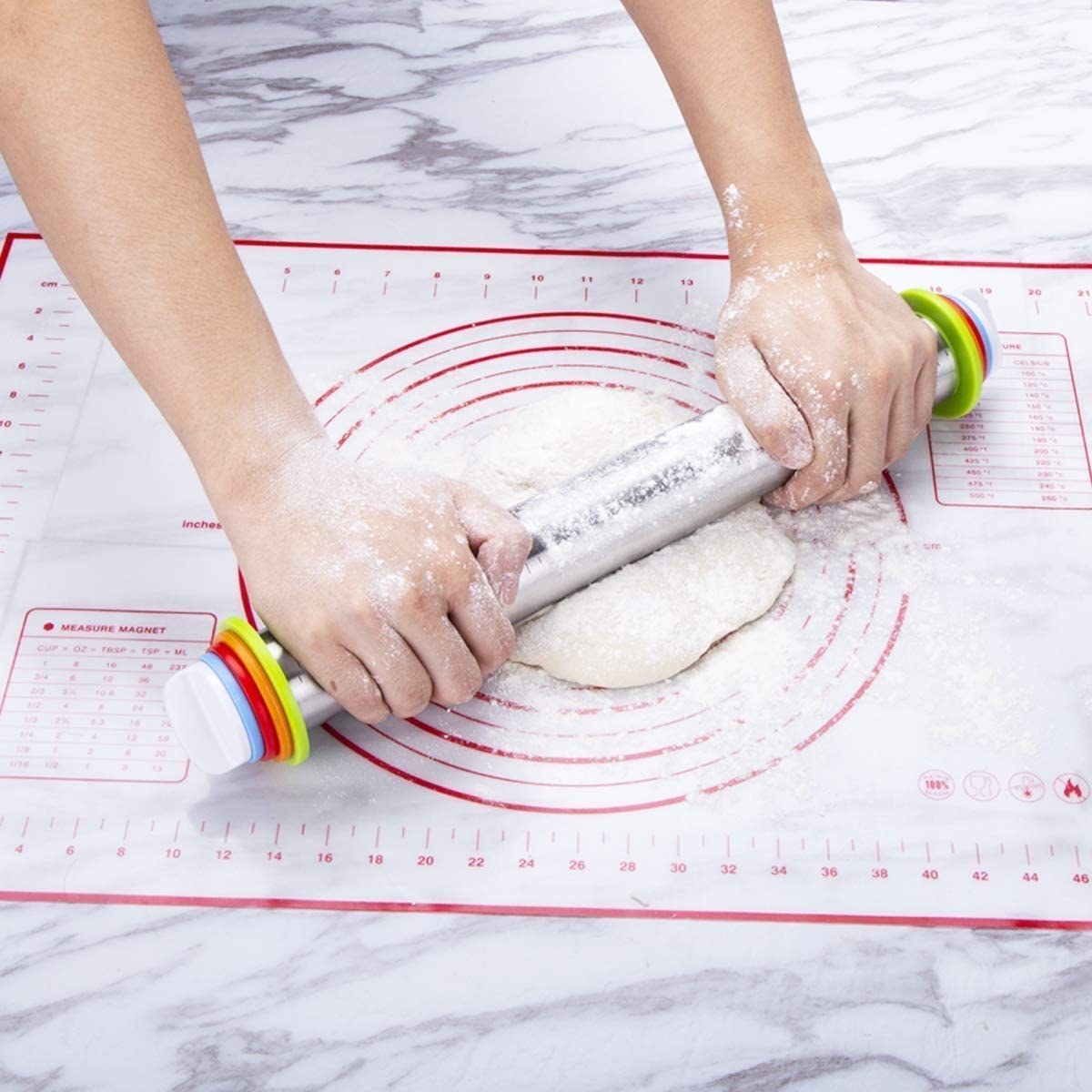 Model using the adjustable rolling pin to roll out dough on top of a baking mat