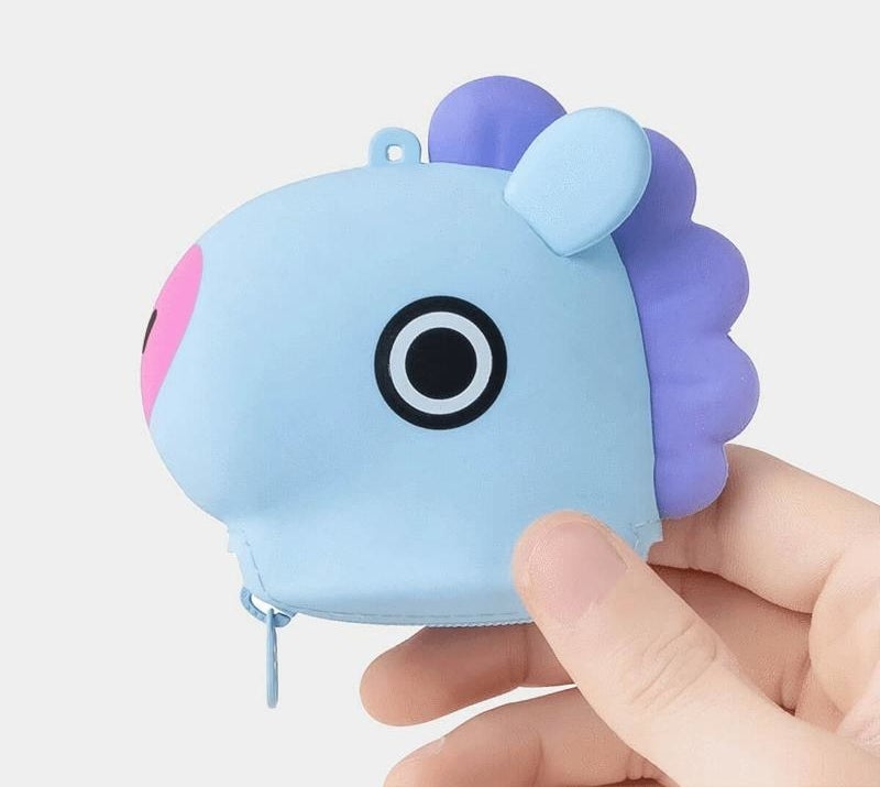 someone holding up a zippered silicone pouch shaped like mang, one of the bt21 characters