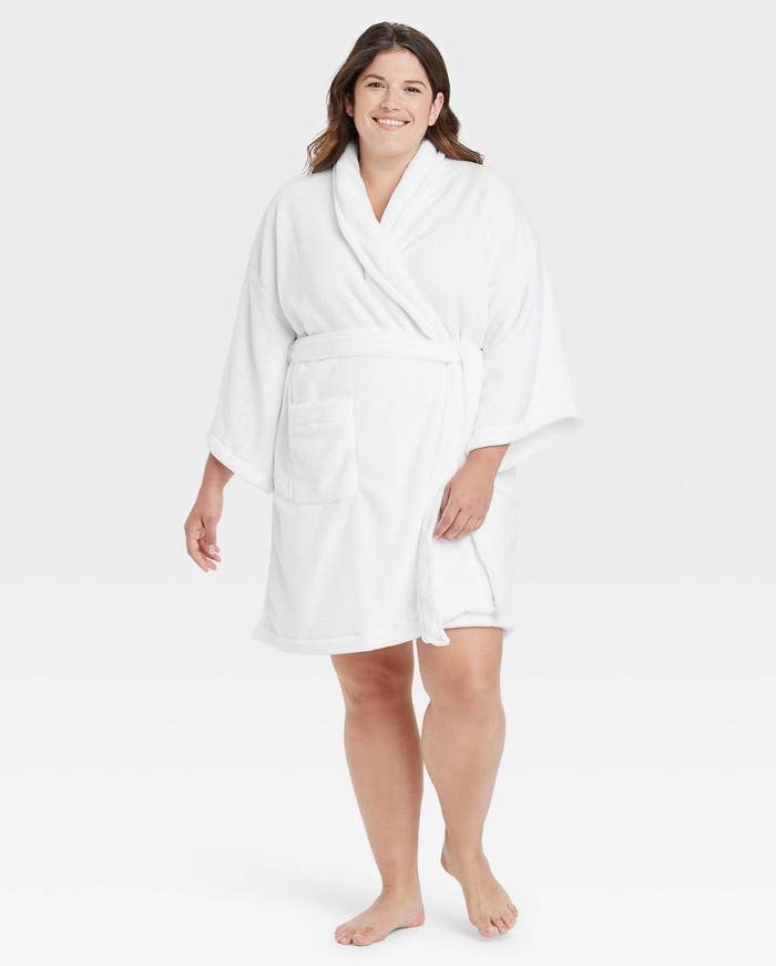 model in a short white robe with long sleeves