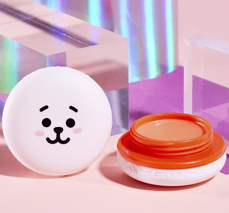 a macaron-shaped lip balm stylized to look like cooky, one of the bt21 characters