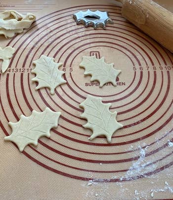 Reviewer photo of leaf-shaped dough being cut out on the baking mat