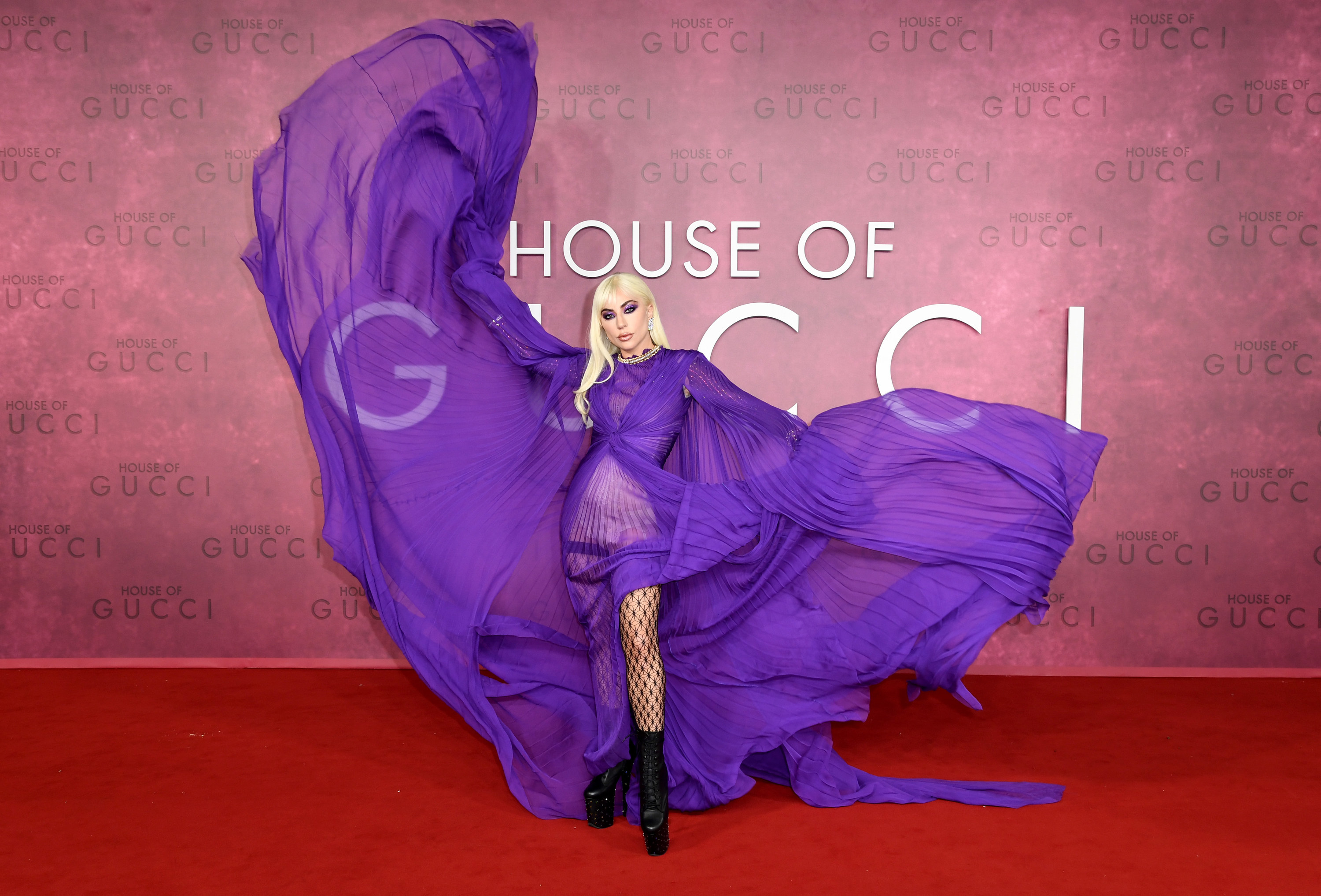 Gaga throwing up her gown so that it flows in the wind on the red carpet