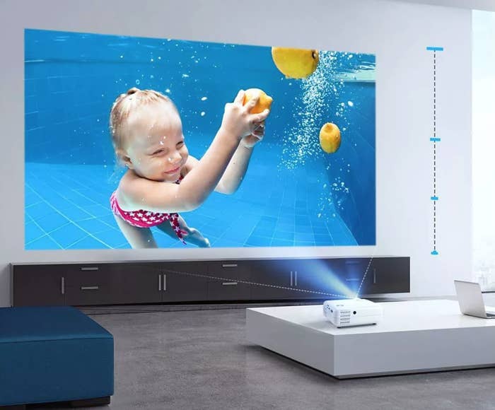 projector showing video on the wall of a child swimming