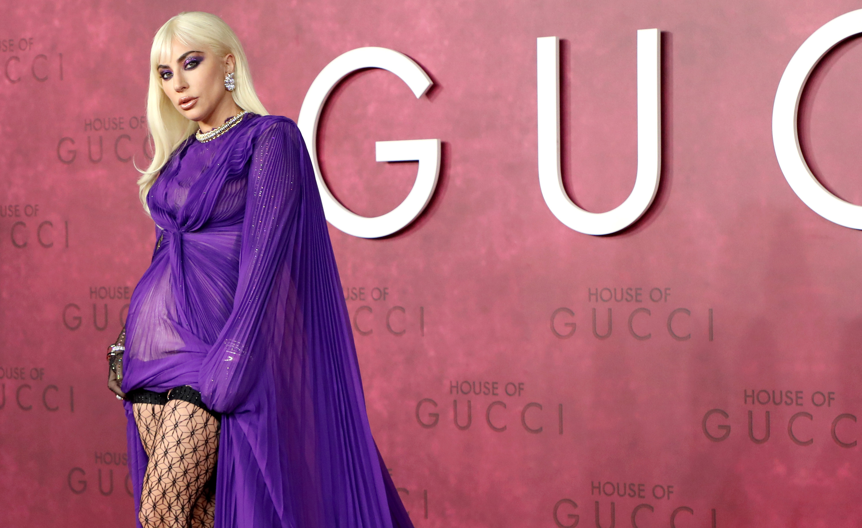 Gaga posing and looking like a total star in front of the House of Gucci sign
