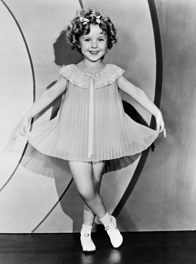 Shirley Temple as a child star, curtseying
