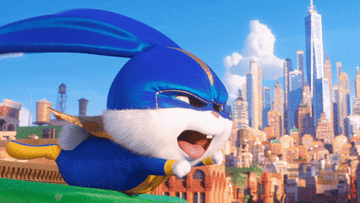 GIF of rabbit in superhero costume pretending to fly