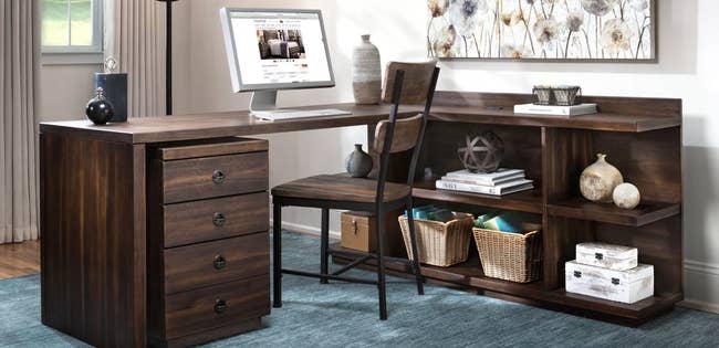 dark brown wooden L-shaped desk with three-shelved attached in office space
