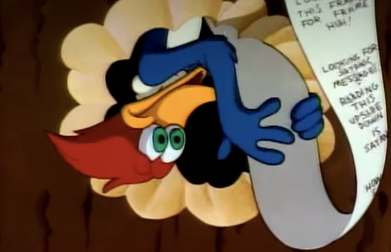 Woody Woodpecker reading a scroll that says, &quot;Looking for Satanic messages? Reading this upside down is Satanic&quot;