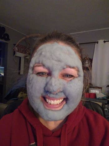 reviewer with a face covered with the carbonated bubble clay mask