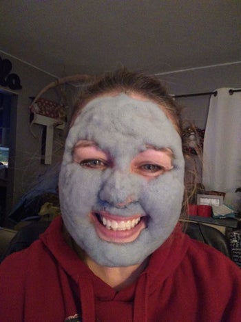 reviewer wearing the carbonated bubble mask and smiling