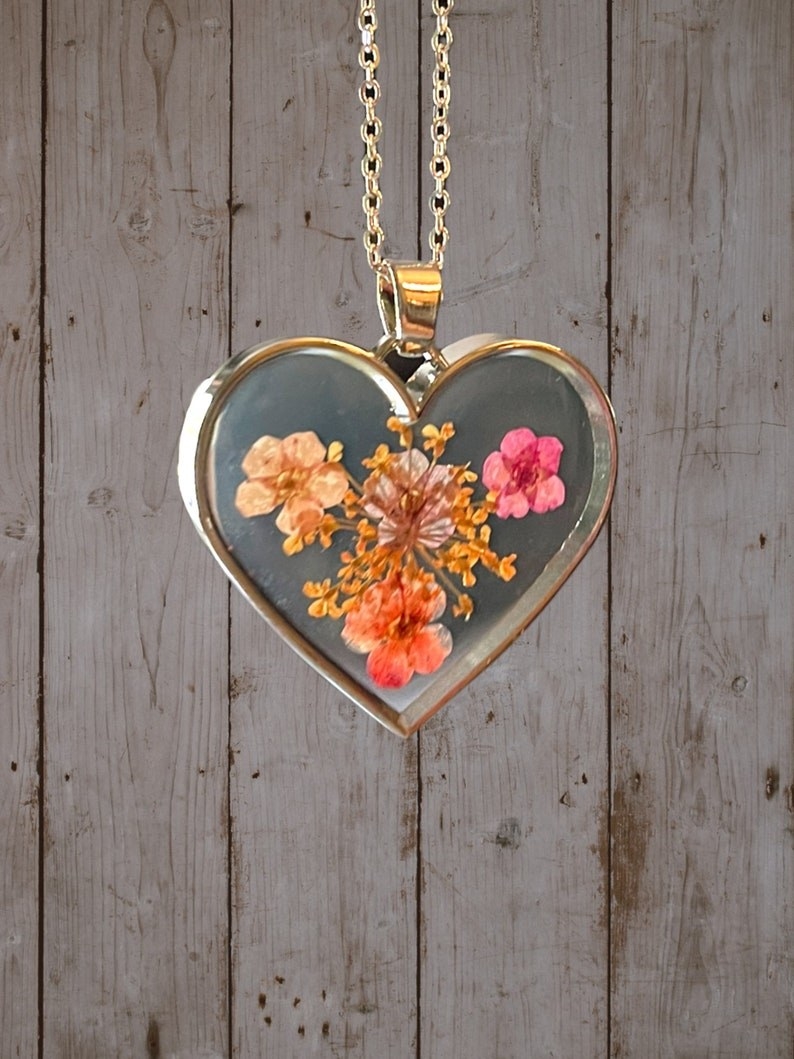 the clear glass pendant with dried pink and orange flowers