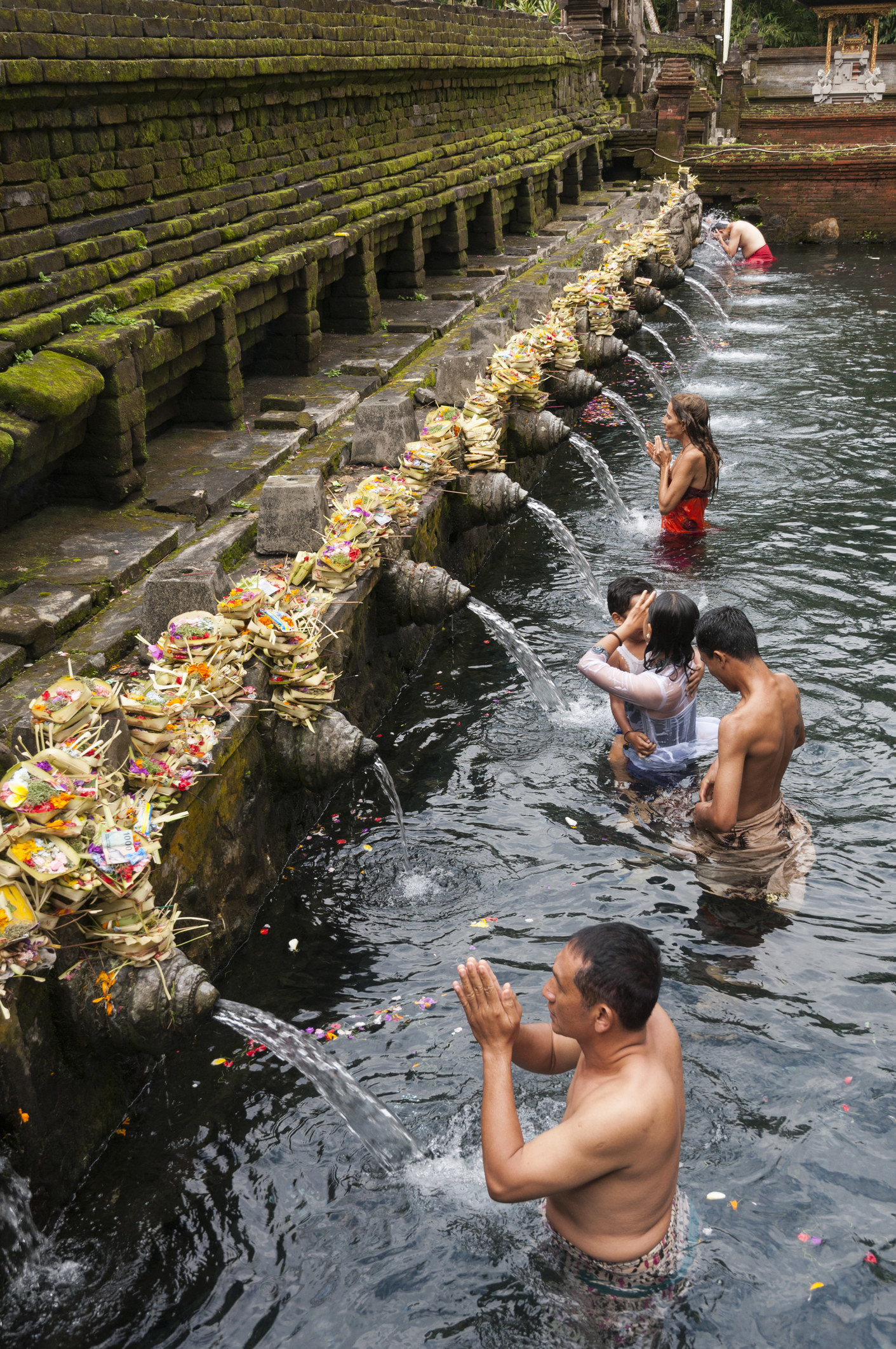 People bathing in the sacred spring at Tirta Empul in Bali.