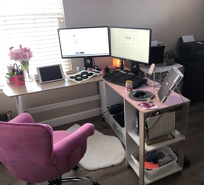 Reviewer's light wood and white desk with two storage shelves next to a pink chair and white area rug