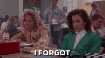 GIF from the movie Heathers: Two teens sit at a table; one of them wears a green blazer and says &quot;I forgot&quot;