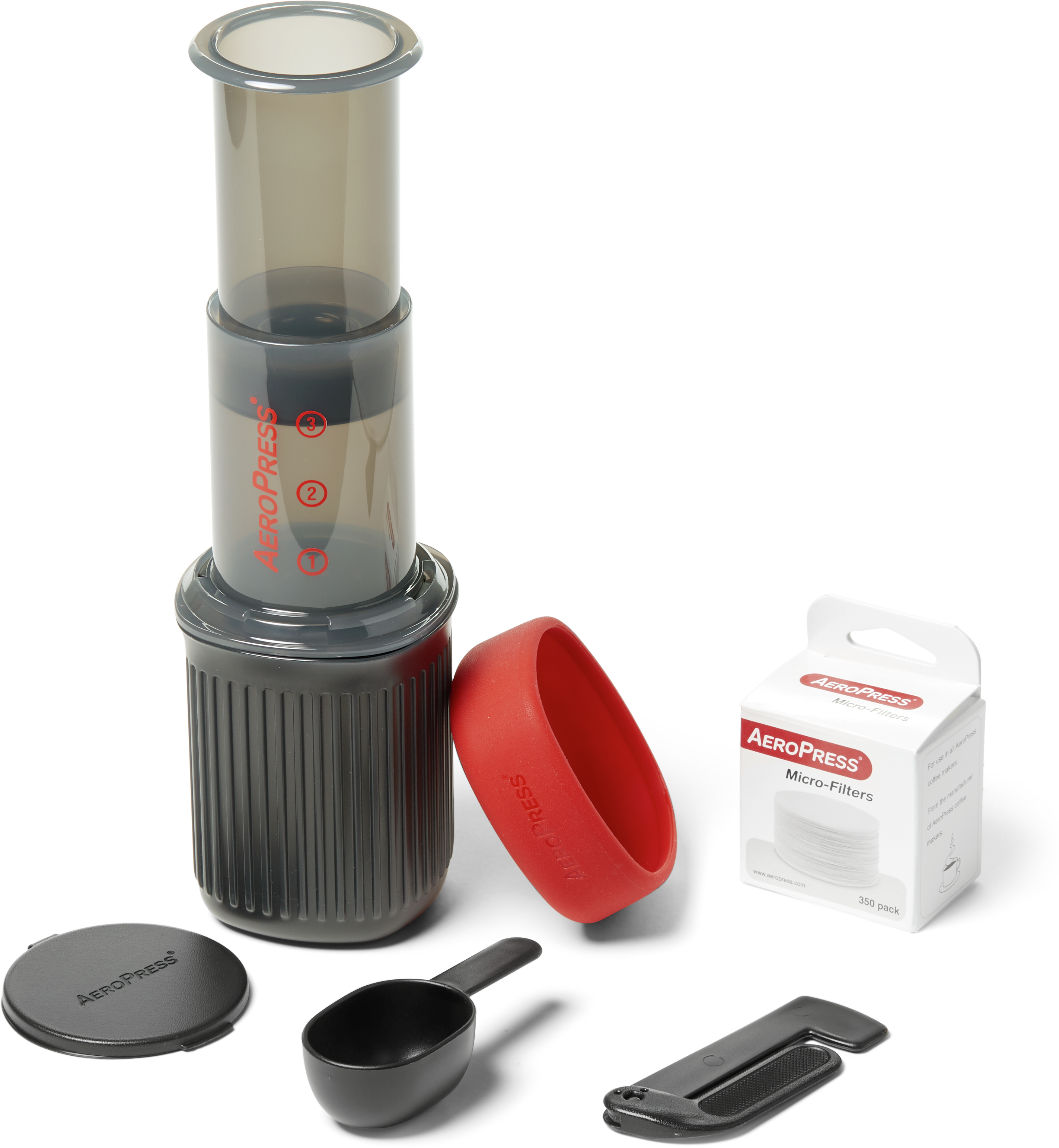 a travel version of the Aeropress Coffee Maker with filter, lid, and scoop.