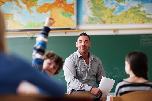 Male teacher at the front of classroom