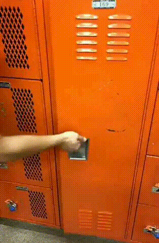 An orange locker is opened. Inside a man sits with his legs up above his ears, like a pretzel