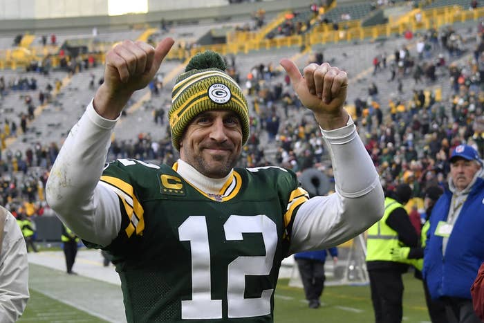 Rodgers gives two thumbs up on a football field