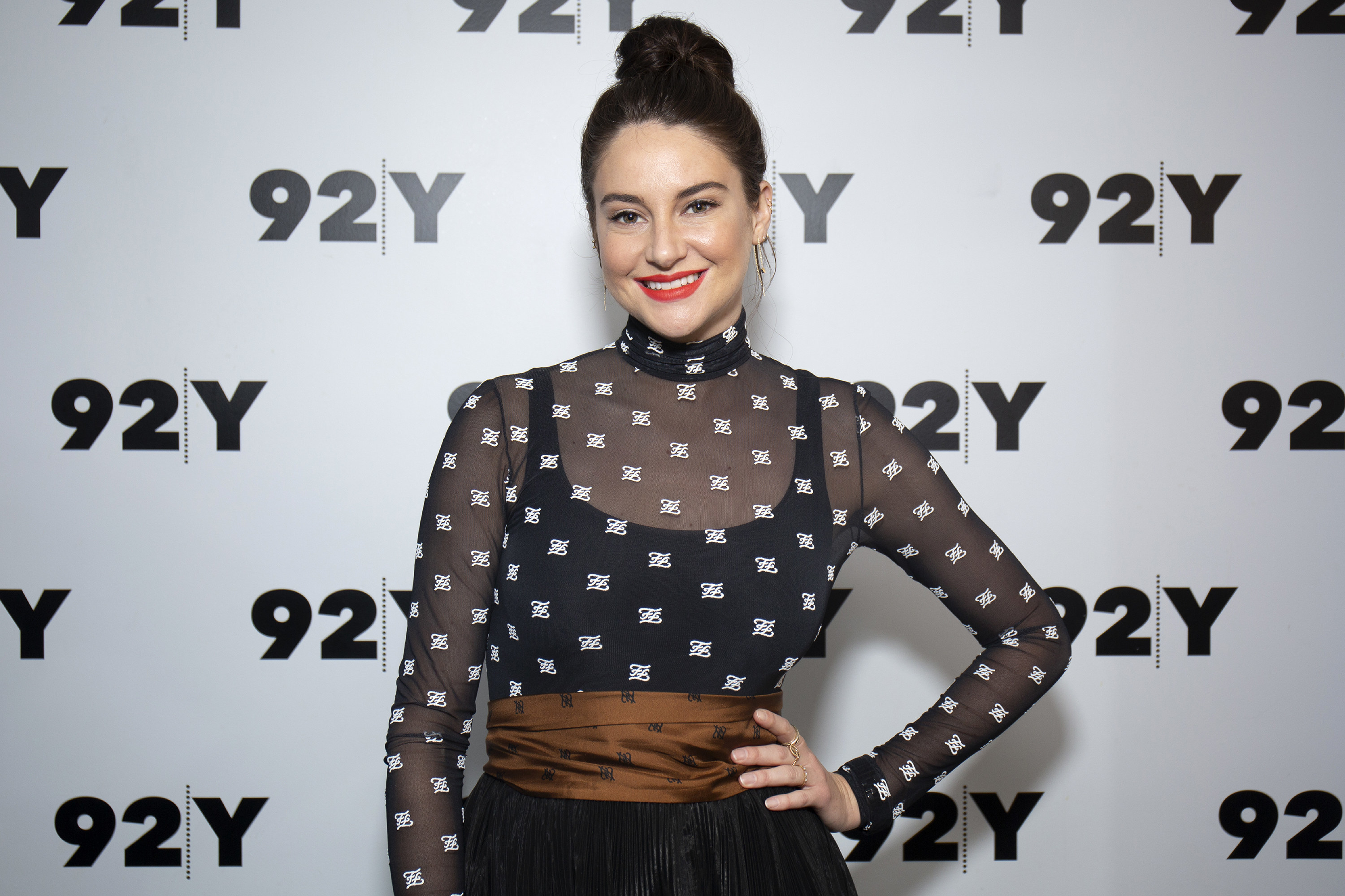 Shailene Woodley stands with her hand on her hip at an event