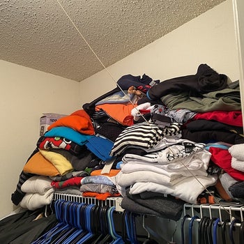 reviewer image of the their closet with a haphazard pile of t-shirts