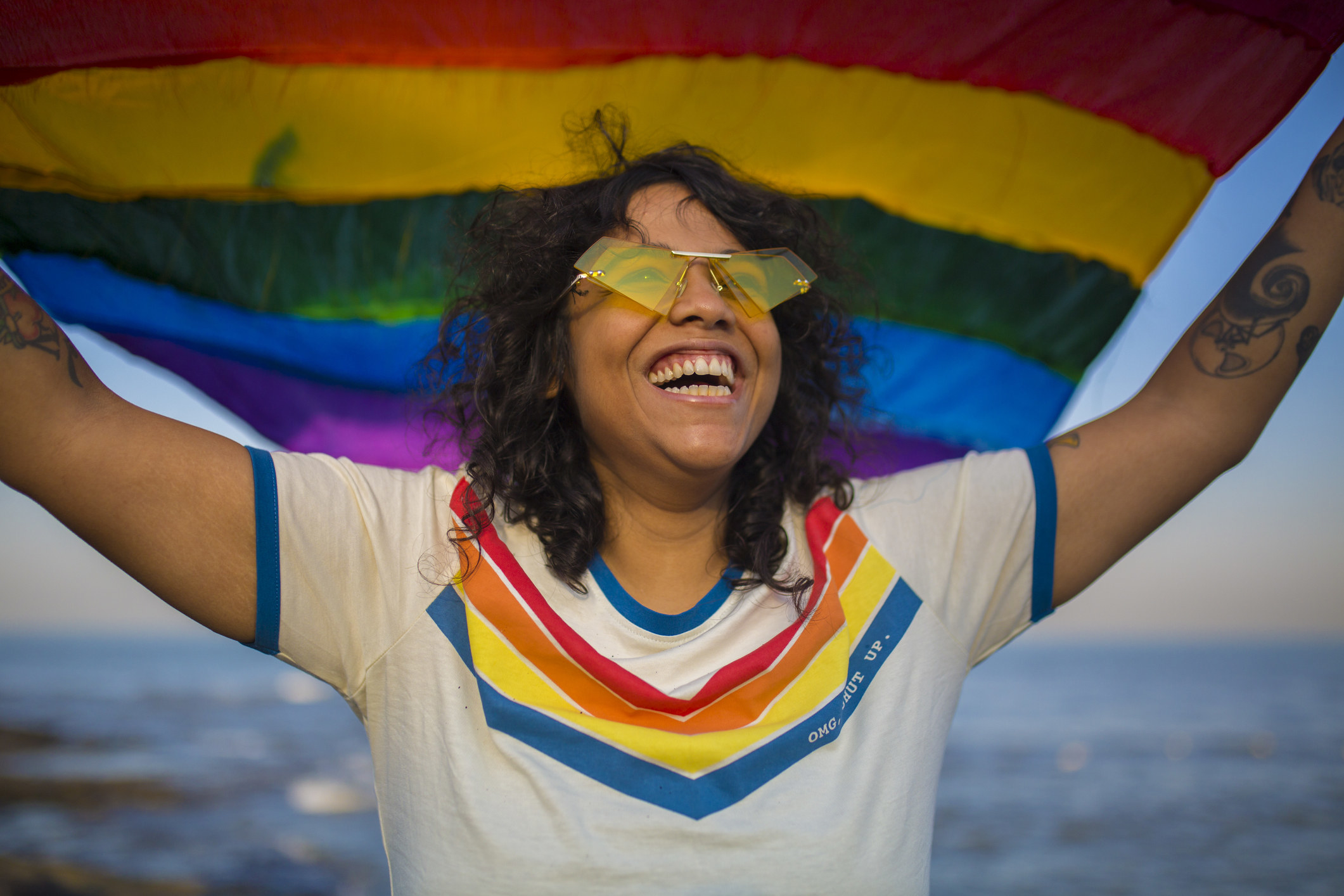 Joyful queer woman with a pride flag