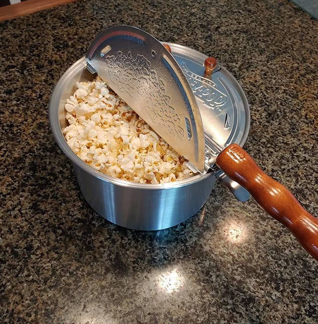 Reviewer's popcorn maker filled with perfectly popped popcorn on a kitchen countertop