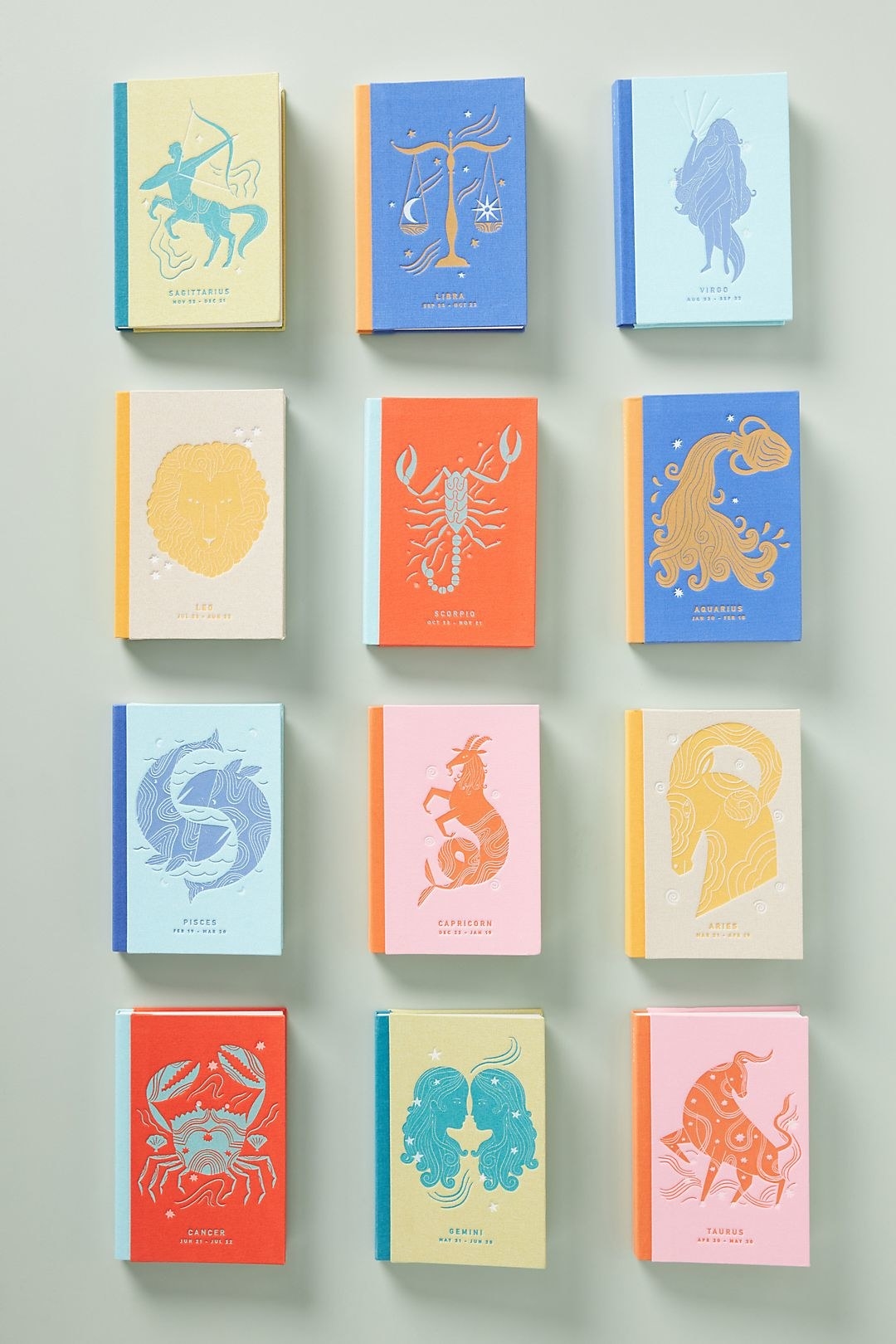 12 different zodiac journals with colorful covers